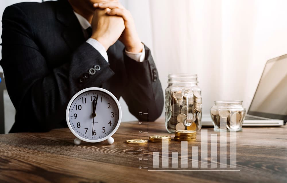 Hand of a lawyer using a calculator to calculate legal costs in a modern law firm