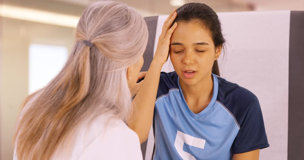 Soccer player with a concussion visiting a doctor for medical assistance