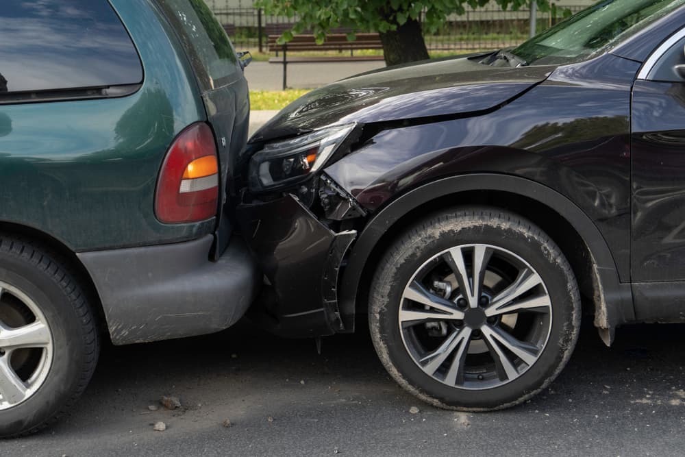 Two damaged cars collide on a street in Miami Gardens, illustrating the aftermath of a car crash accident.