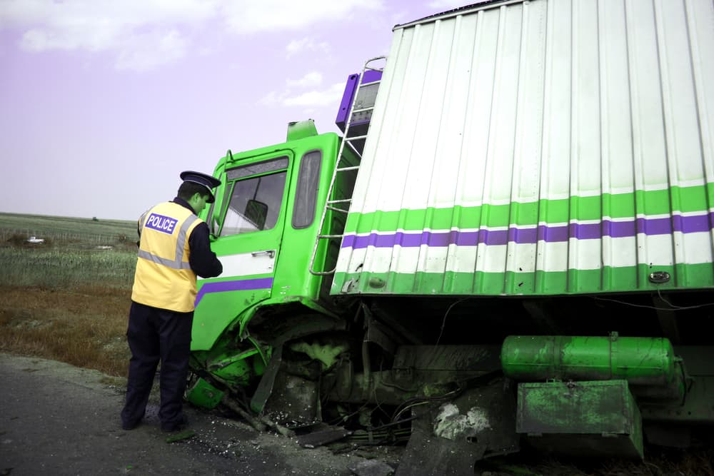 After accident, a damaged truck out of the road.